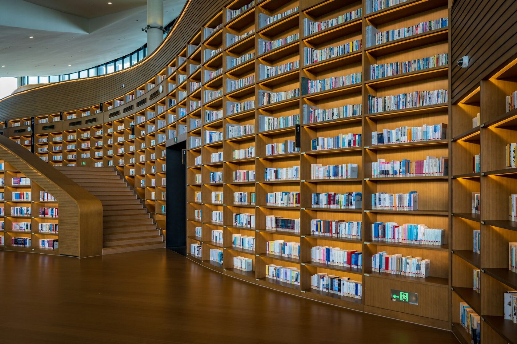 Library reading room with tall timber shelving