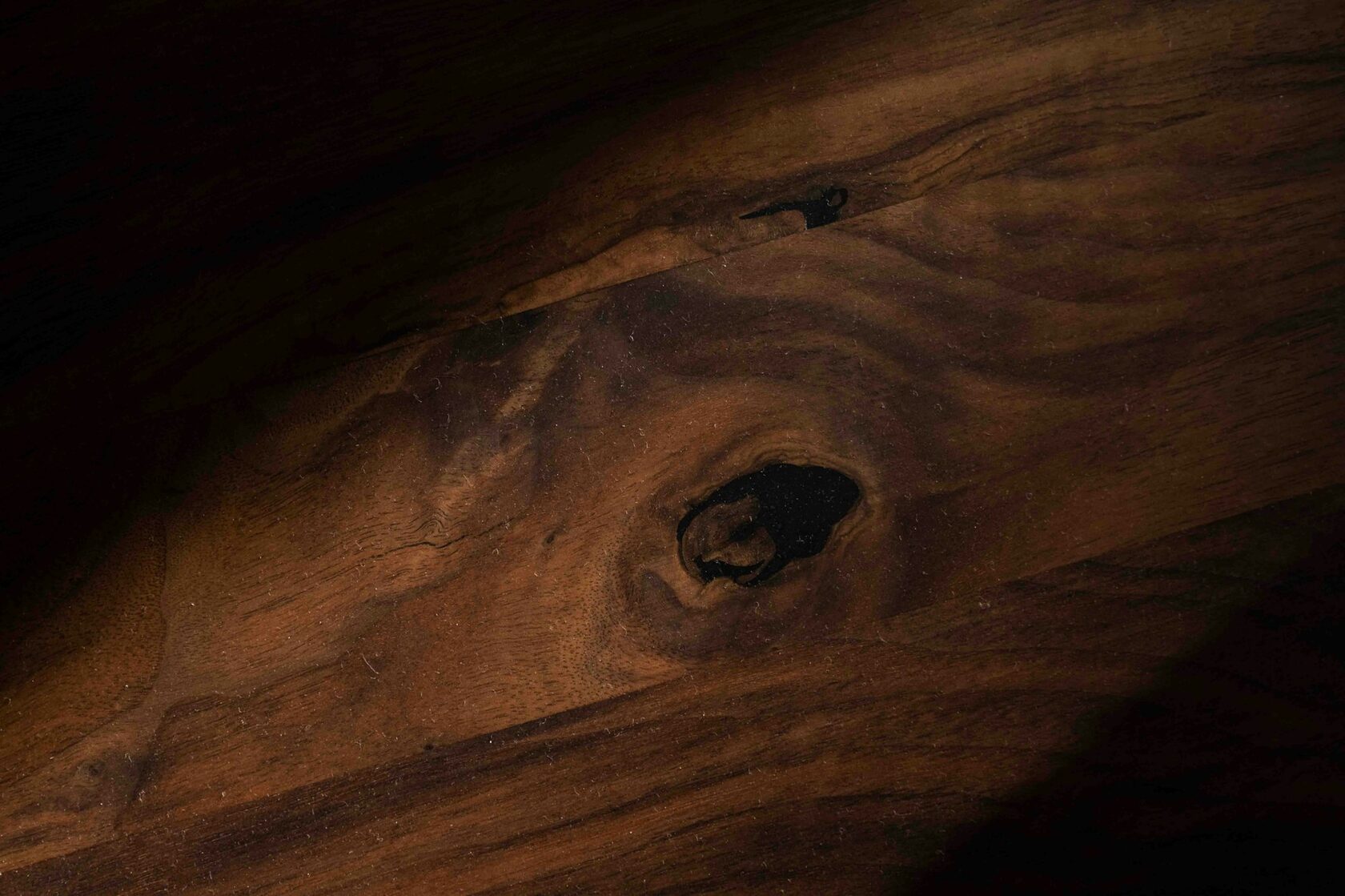 Close-up of a dark walnut surface showing grain