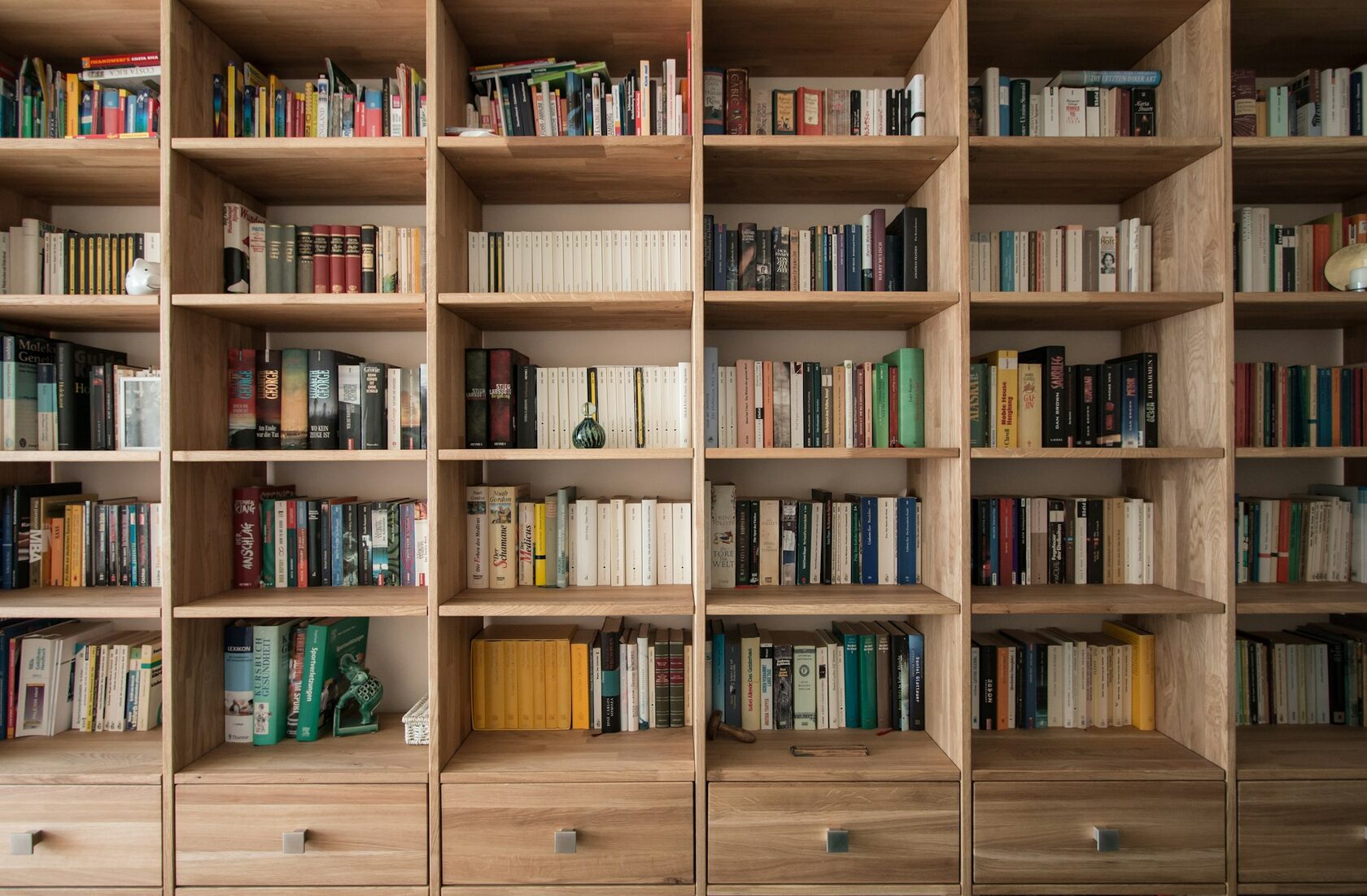 Built-in bespoke timber shelving fitted into a residential wall